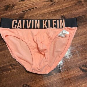 NWOT. Calvin Klein men’s briefs, size Med. black and coral.